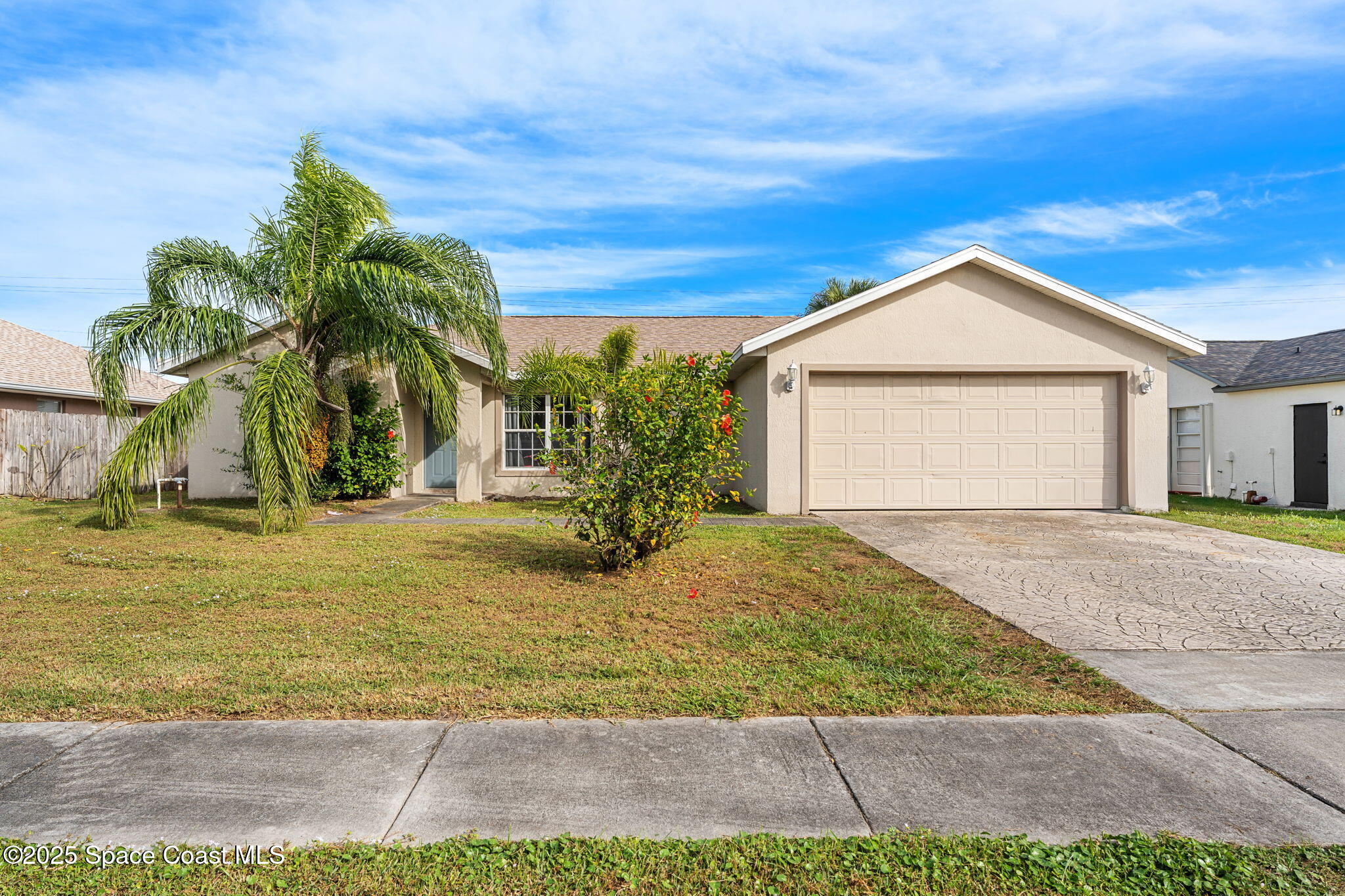 a view of a yard in front of a house with a garage