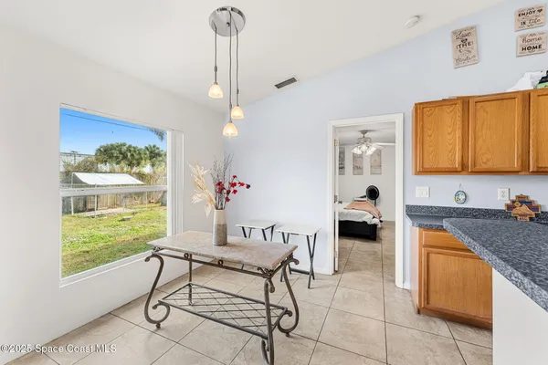 a kitchen with granite countertop white cabinets and stainless steel appliances