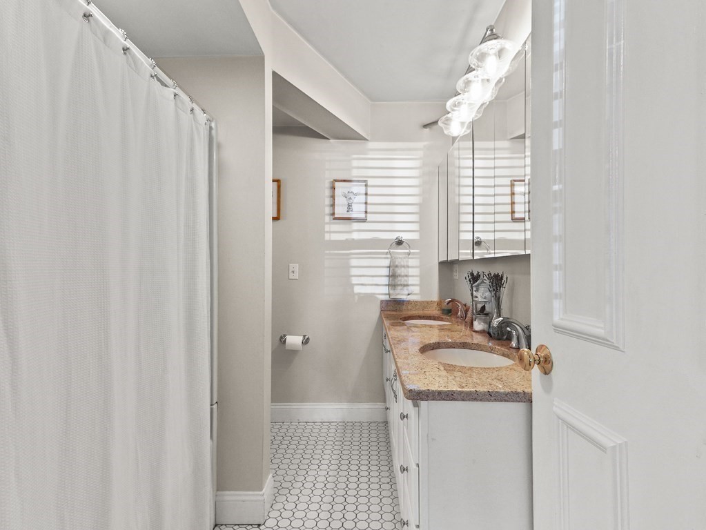 16 Garrison Road, Unit 8 Brookline, MA 02445 - Photo 15 of 20 a bathroom with a sink a toilet and a window