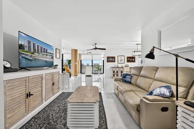 a kitchen with stainless steel appliances kitchen island granite countertop a refrigerator and cabinets