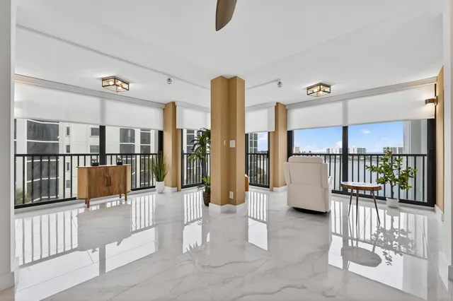 a living room with furniture and a floor to ceiling window