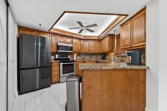 a kitchen with stainless steel appliances granite countertop a stove microwave and cabinets