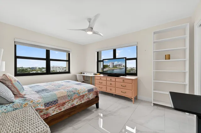 a spacious bathroom with a granite countertop sink a toilet and a mirror