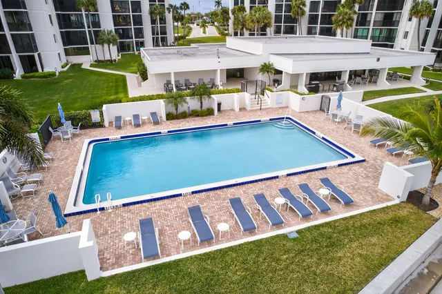 a view of a house with a yard deck and sitting area