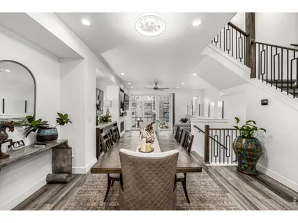 a dining room with furniture and wooden floor