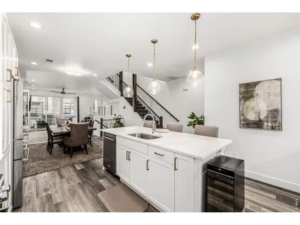 a kitchen with a sink a stove and chairs