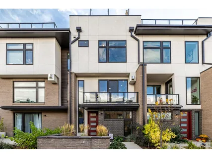 a view of a building with a window and a wooden fence