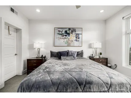 a bedroom with a bed and a lamp