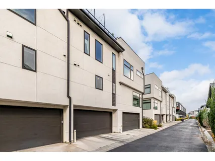 a view of a street with wooden fence