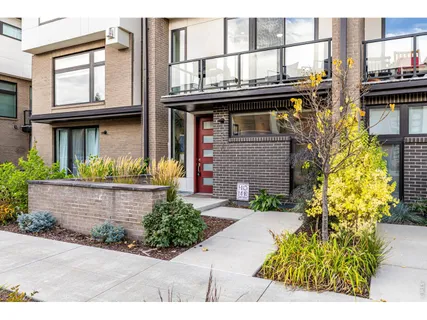a view of a house with potted plants