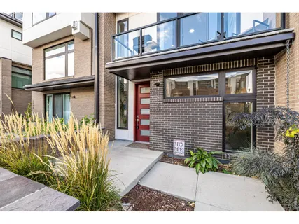 a front view of a house with a garden and plants