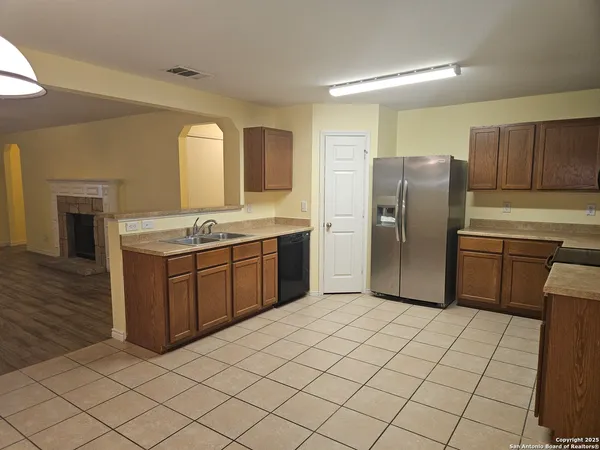 a kitchen with stainless steel appliances a refrigerator sink and cabinets