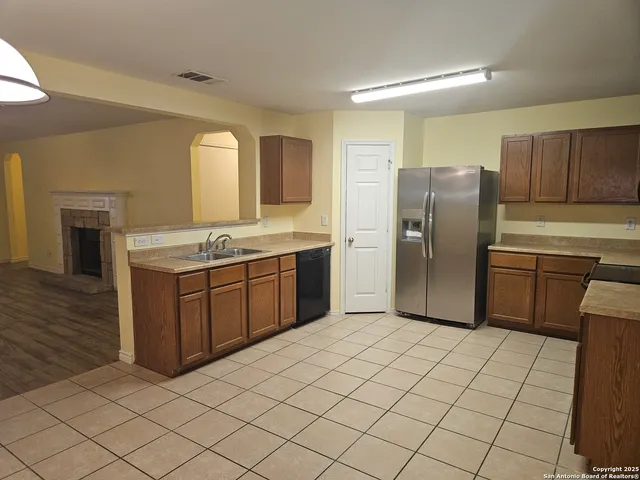 a kitchen with stainless steel appliances a refrigerator sink and cabinets