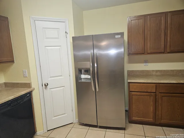 a kitchen with metallic refrigerator freezer and a dishwasher