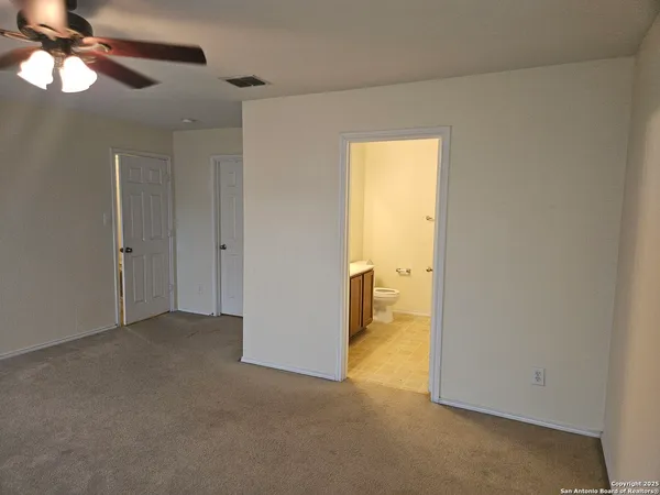 a view of a room with a ceiling fan