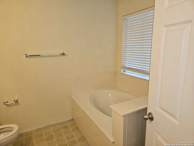 a white bath tub sitting next to a white sink