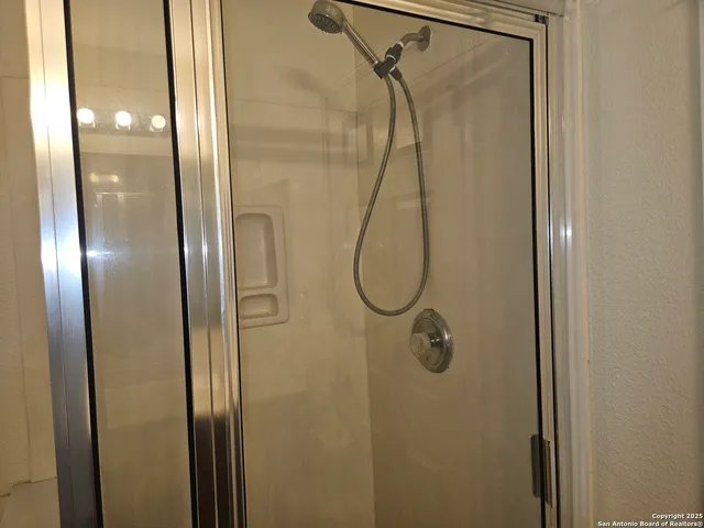 a bathroom with a glass shower door