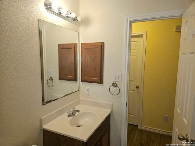 a bathroom with a sink a mirror and shower
