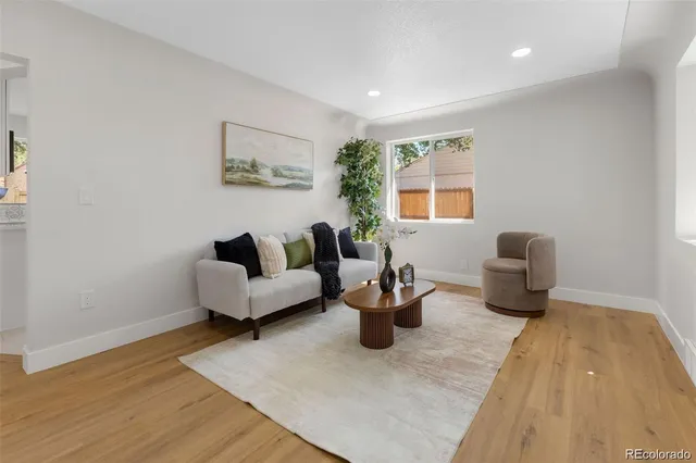 a living room with furniture a rug and a window
