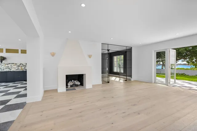 a view of an empty room with a fireplace and a window