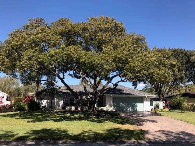 4631 Glebe Farm Road Sarasota, FL 34235 - Photo 1 of 1 a front view of a house with a yard