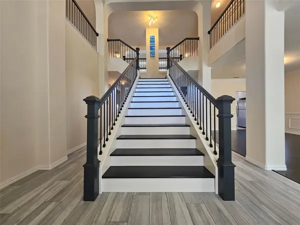 a view of entryway and hall with wooden floor