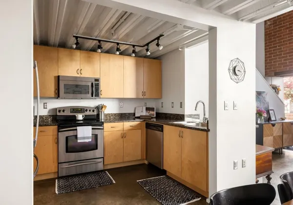 a kitchen with stainless steel appliances granite countertop a stove and a refrigerator