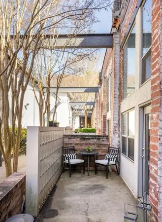a view of a chairs and fire pit in the patio of a house