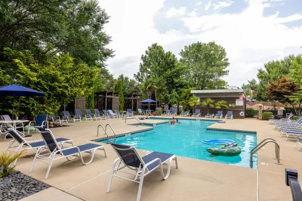 a view of a swimming pool and lounge chairs