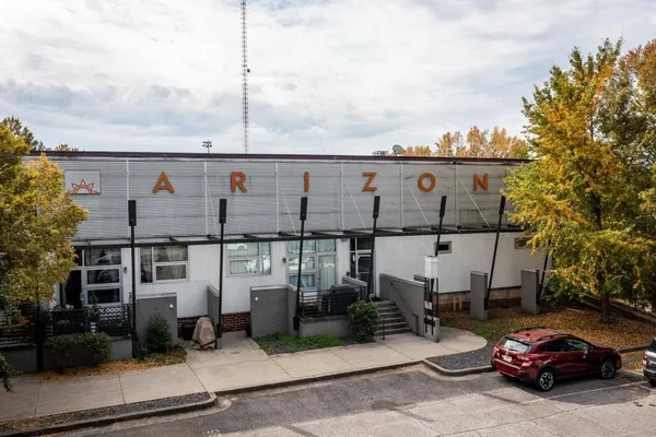 a view of a cars park in front of a building