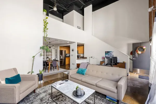 a living room with furniture and wooden floor