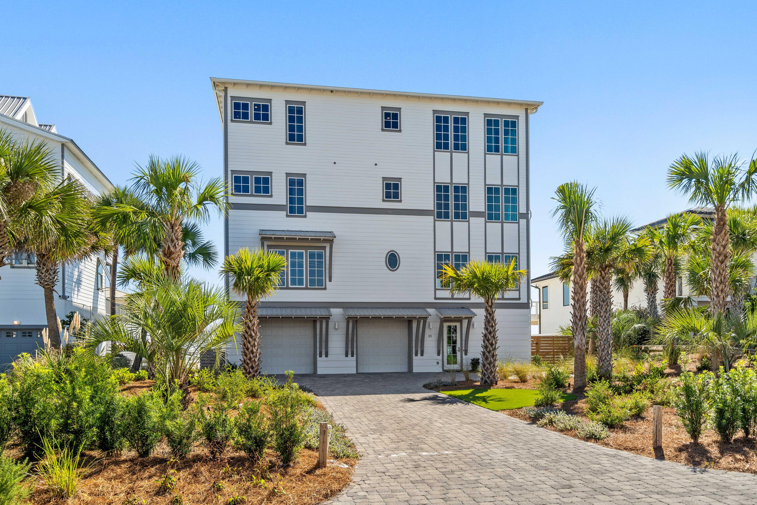 25 Fort Panic Road Santa Rosa Beach, FL 32459 - Photo 76 of 88 a front view of a house with glass windows and a yard