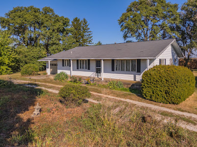 23641 North 100 E Road Flanagan, IL 61740 - Photo 1 of 30 a front view of a house with a garden and yard