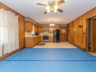 23641 North 100 E Road Flanagan, IL 61740 - Photo 13 of 30 a room with stainless steel appliances kitchen island granite countertop a refrigerator a stove a microwave oven with a dining table and chairs