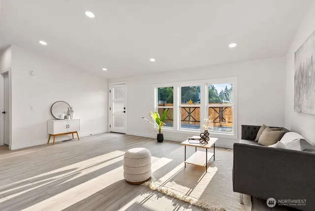 a kitchen with stainless steel appliances a dining table chairs microwave and sink