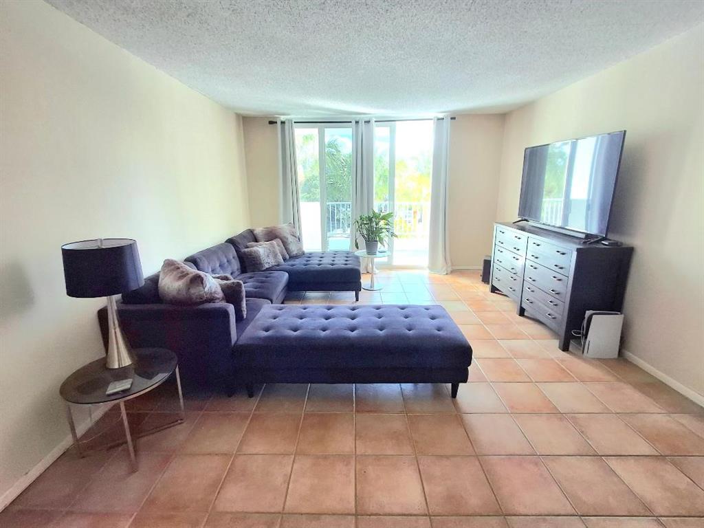 1421 South Ocean Boulevard, Unit 310 Pompano Beach, FL 33062 - Photo 3 of 26 a living room with furniture and a large window