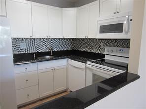 1421 South Ocean Boulevard, Unit 310 Pompano Beach, FL 33062 - Photo 4 of 26 a kitchen with white cabinets and sink
