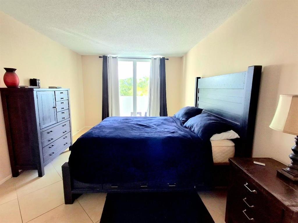 1421 South Ocean Boulevard, Unit 310 Pompano Beach, FL 33062 - Photo 6 of 26 a bedroom with a bed and window