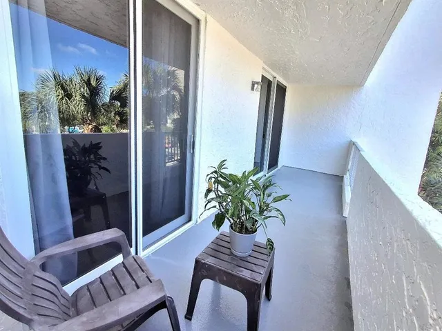 a view of a hallway with furniture and front door