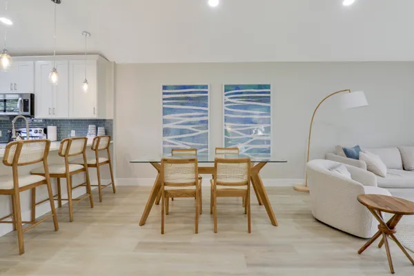 a dining room with furniture and wooden floor
