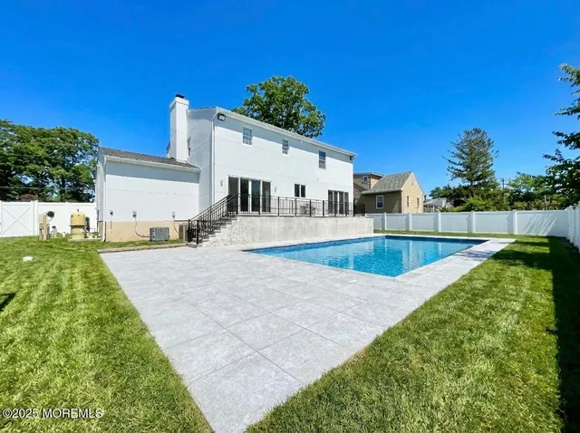 a view of a backyard patio and fire pit