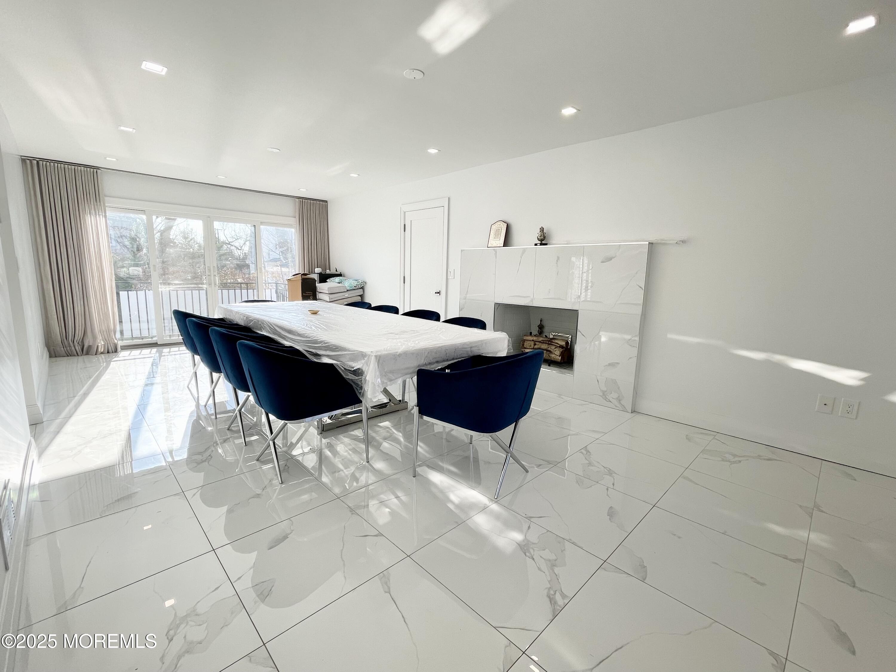 7 Berger Avenue Oakhurst, NJ 07755 - Photo 3 of 14 a kitchen with stainless steel appliances kitchen island granite countertop a sink and a white cabinets