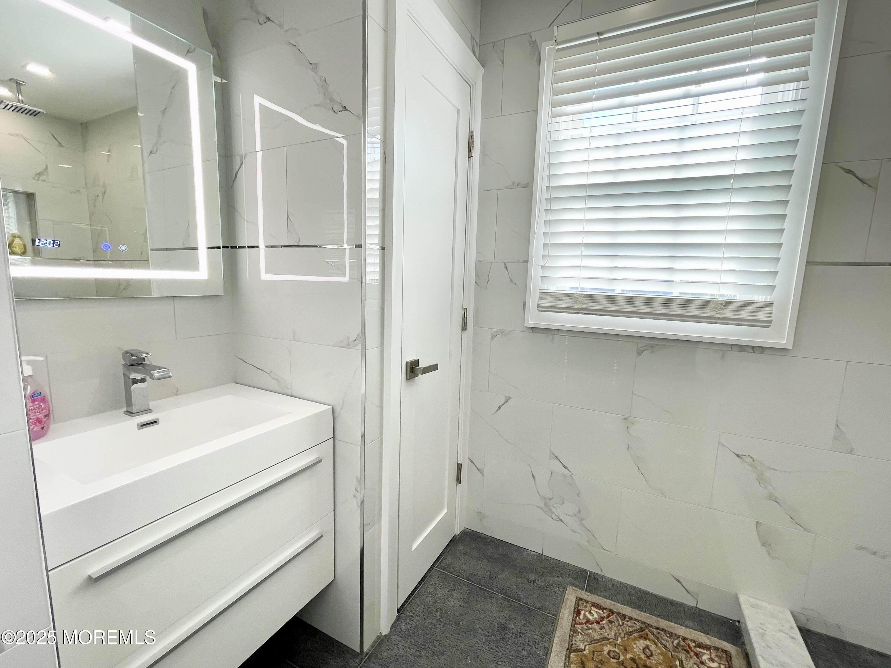 7 Berger Avenue Oakhurst, NJ 07755 - Photo 6 of 14 a bathroom with a sink and a bathtub