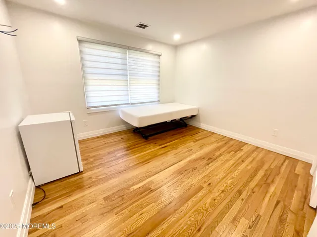 a living room with a wooden floor and a table