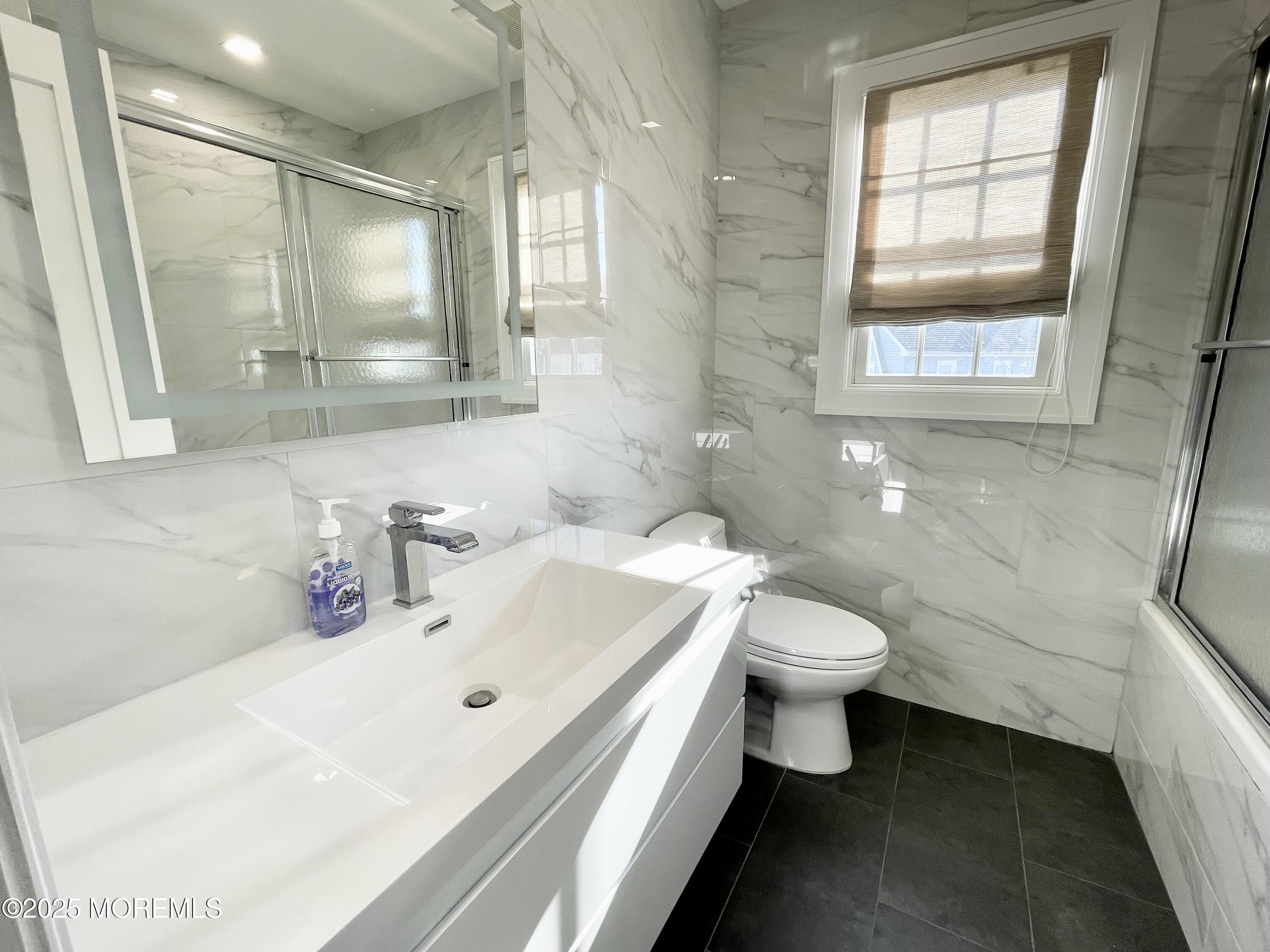 7 Berger Avenue Oakhurst, NJ 07755 - Photo 8 of 14 a bathroom with a sink a toilet and mirror