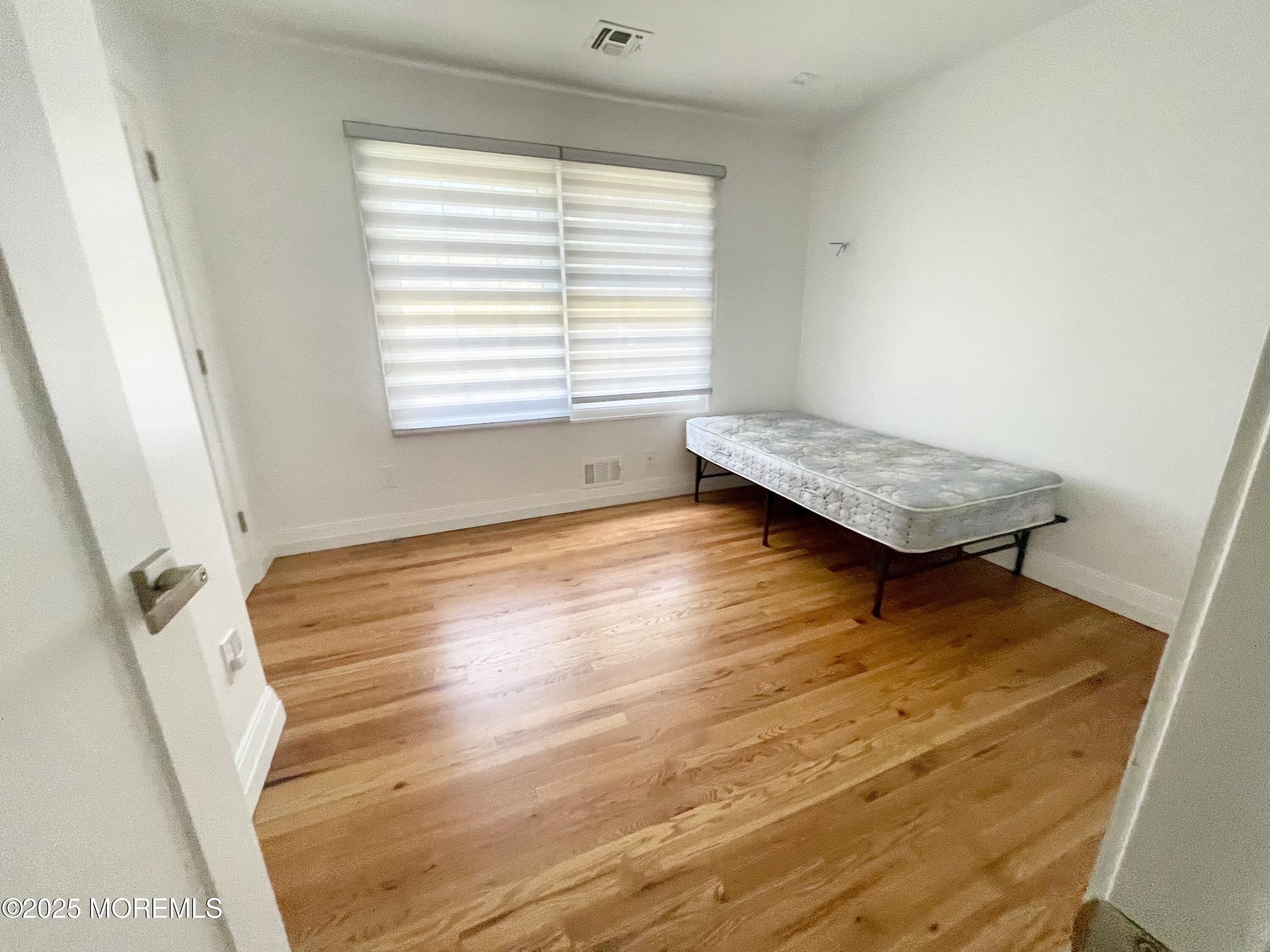 7 Berger Avenue Oakhurst, NJ 07755 - Photo 9 of 14 a room with wooden floor and window