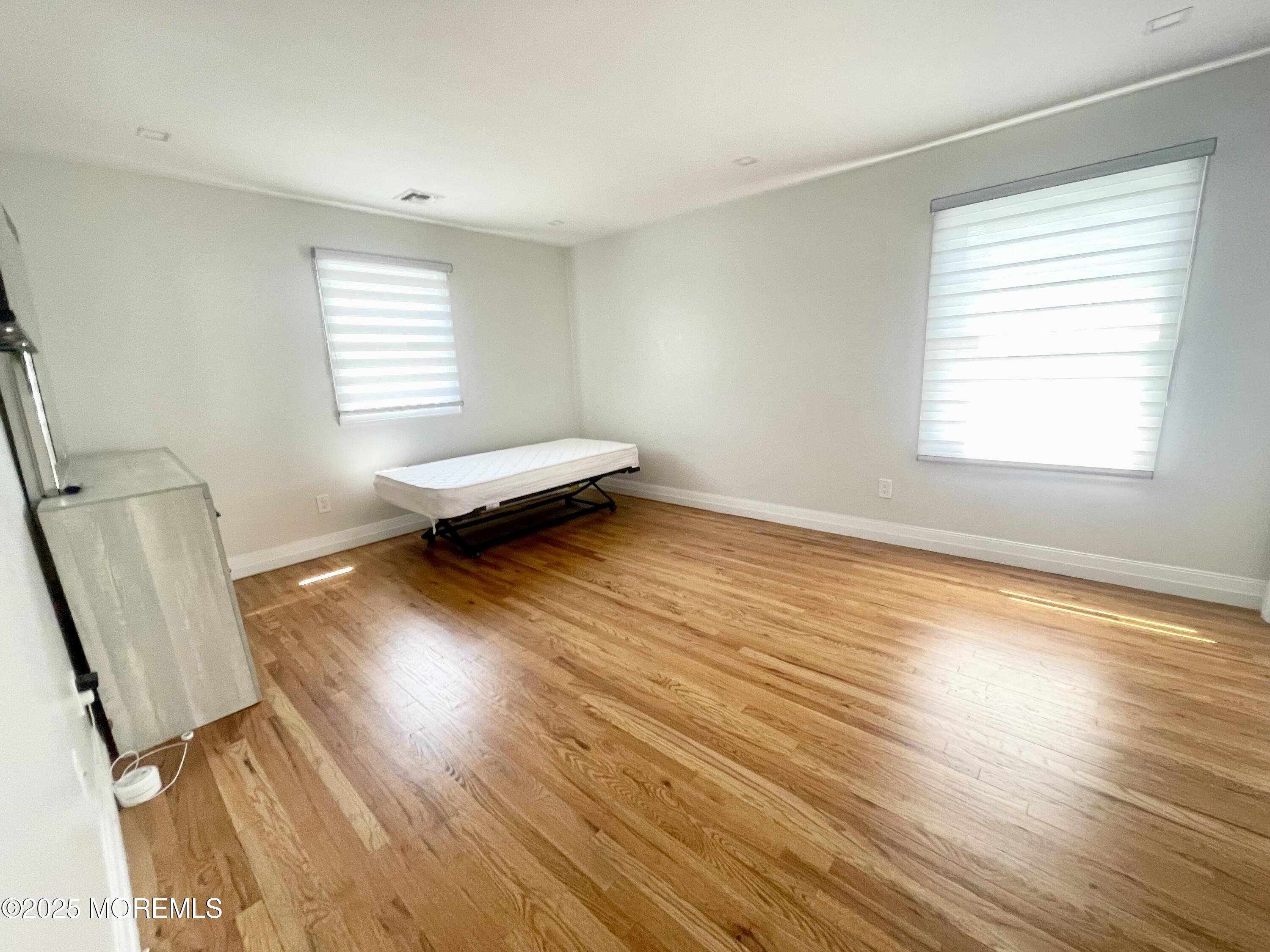 7 Berger Avenue Oakhurst, NJ 07755 - Photo 10 of 14 a living room with wooden floor and a window