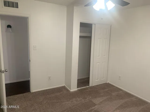 an empty room with closet area