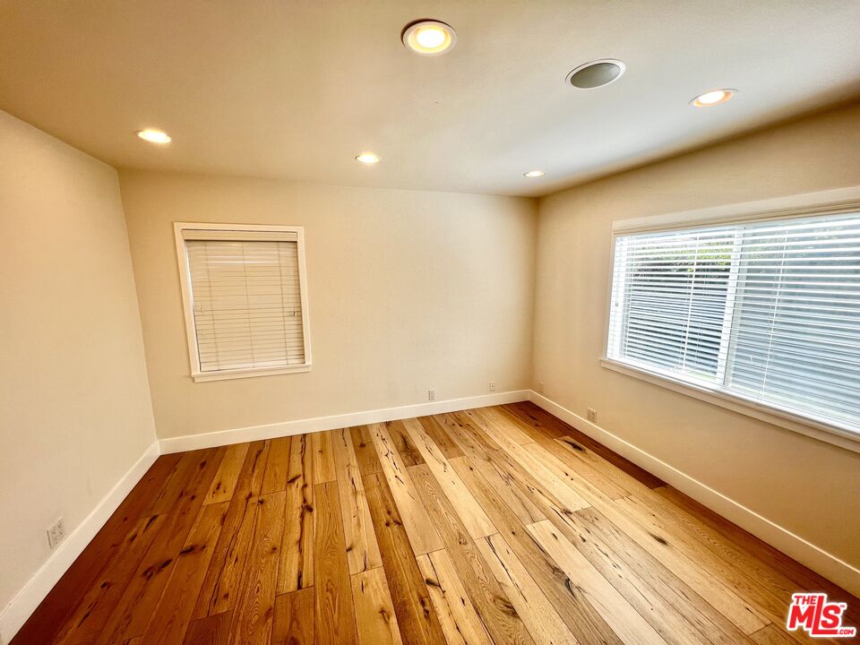 5757 Vesper Avenue Van Nuys, CA 91411 - Photo 11 of 26 a view of an empty room with wooden floor and a window