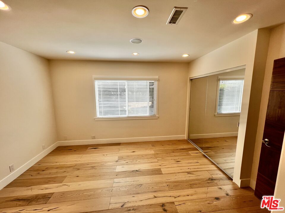 5757 Vesper Avenue Van Nuys, CA 91411 - Photo 12 of 26 a view of an empty room with wooden floor and a window